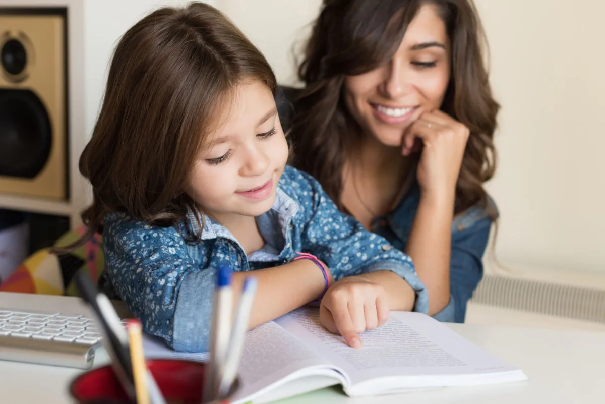 mother helping child with homework RBWNXEN 1